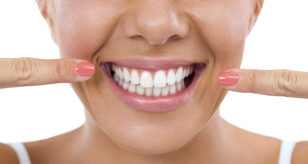 Woman showing her perfect straight white teeth.