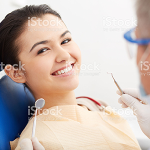 Image of smiling patient looking at camera at the dentistís